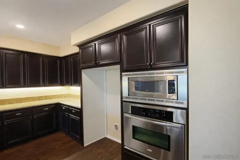 a kitchen with granite countertop a stove and a microwave