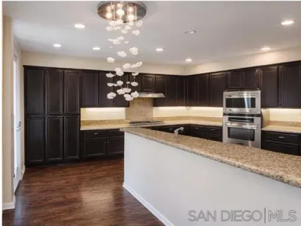 a kitchen with stainless steel appliances a sink a stove a microwave and cabinets