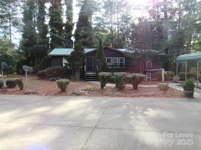 a front view of a house with a yard and seating space