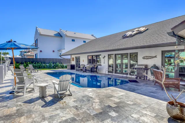 an aerial view of residential houses with outdoor space and swimming pool