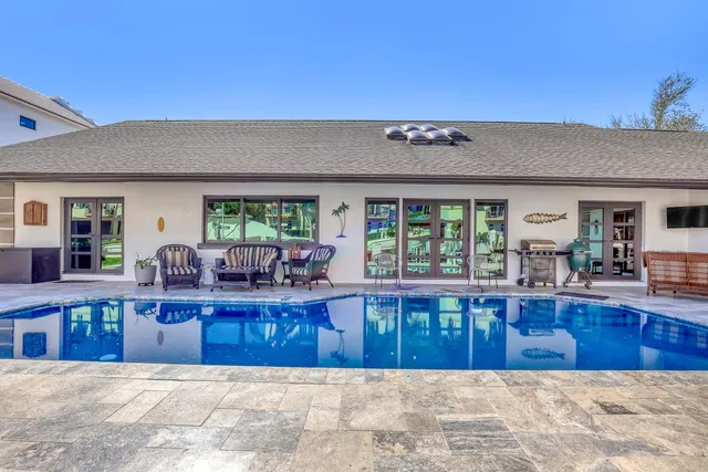 an aerial view of a city with lots of residential buildings ocean and mountain view in back