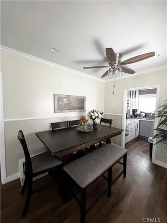 a living room with furniture a chandelier and a wooden floor