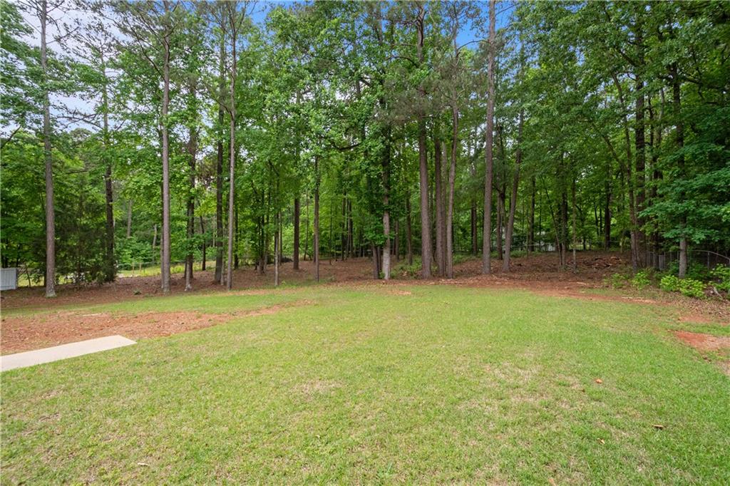405 Ridgemont Drive Fayetteville, GA 30215 - Photo 34 of 43 a backyard of a house with lots of green space
