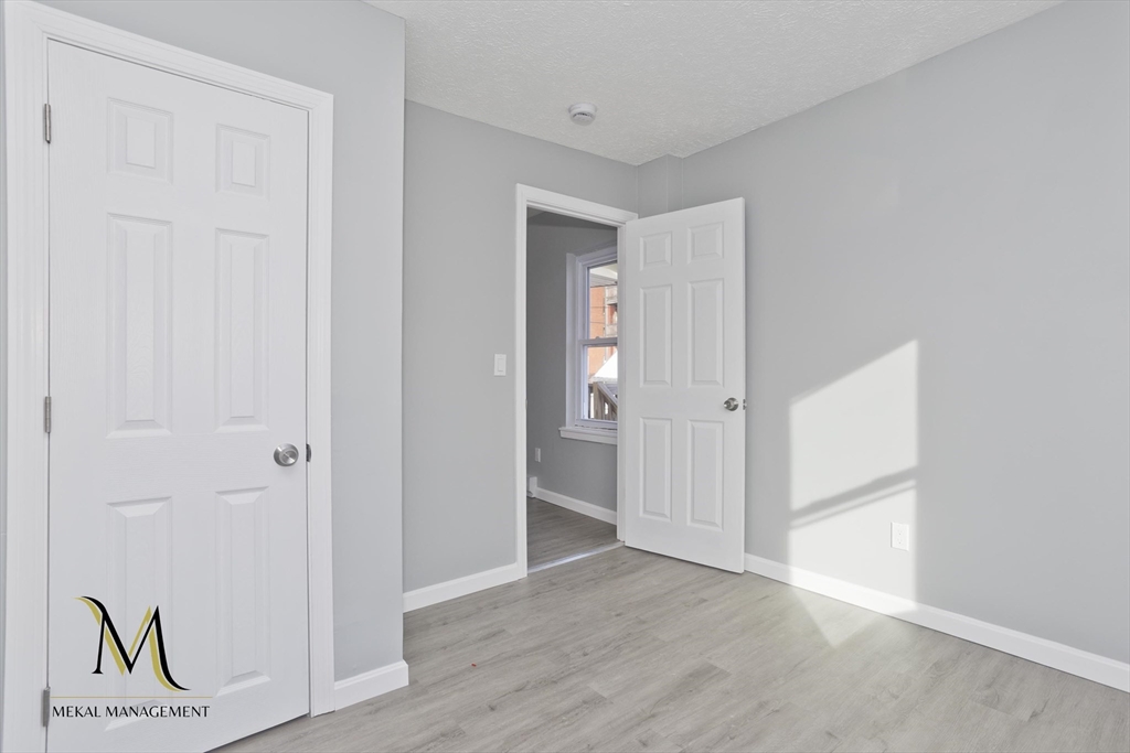 131 Center Street, Unit 131 Holyoke, MA 01040 - Photo 12 of 12 an empty room with wooden floor