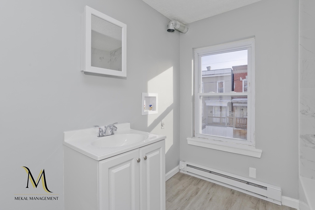 131 Center Street, Unit 131 Holyoke, MA 01040 - Photo 7 of 12 a bathroom with a sink and a mirror