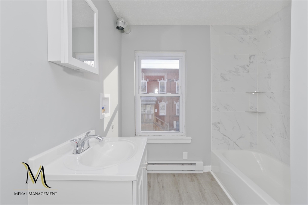 131 Center Street, Unit 131 Holyoke, MA 01040 - Photo 8 of 12 a bathroom with a sink and a mirror