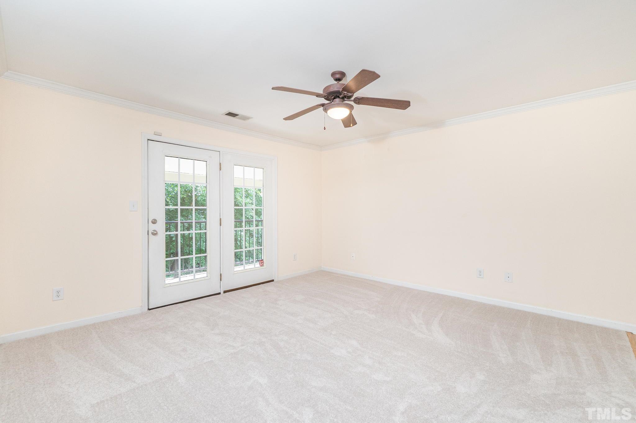 2308 Myron Drive, Unit 203 Raleigh, NC 27607 - Photo 8 of 26 an empty room with windows and fan