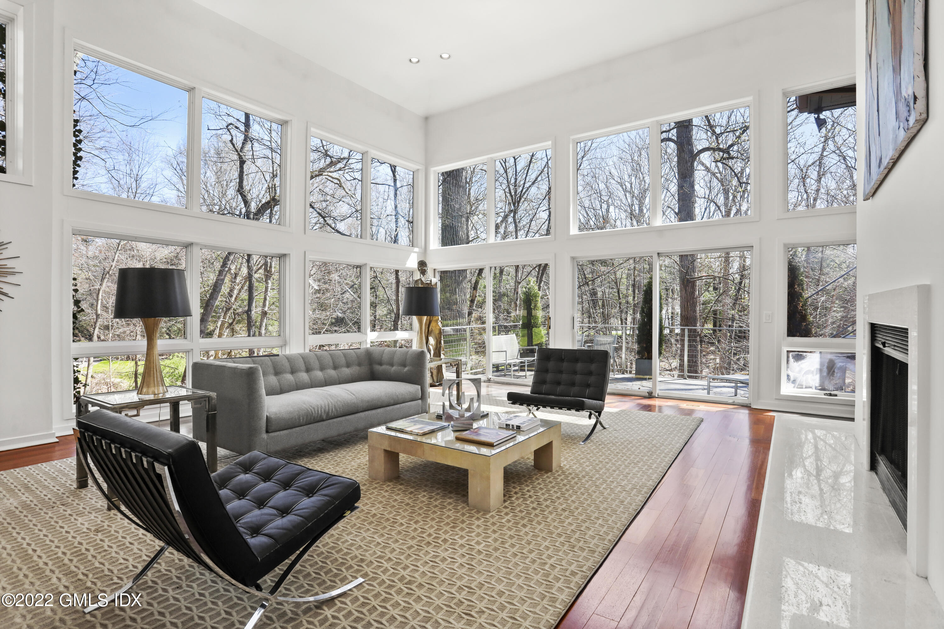 4 Chateau Ridge Road Greenwich, CT 06831 - Photo 12 of 37 a living room with furniture large windows and a fireplace