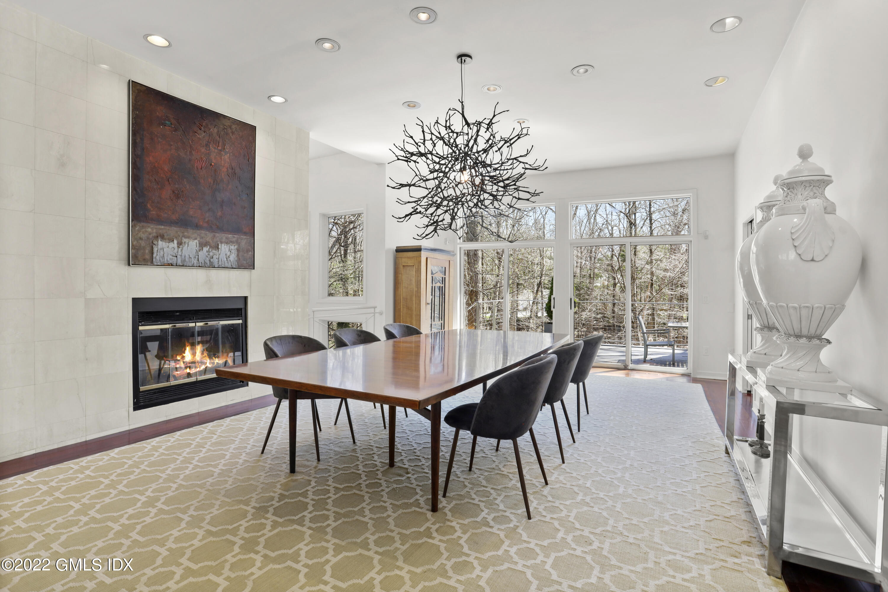 4 Chateau Ridge Road Greenwich, CT 06831 - Photo 14 of 37 a dining room with furniture a fireplace and wooden floor