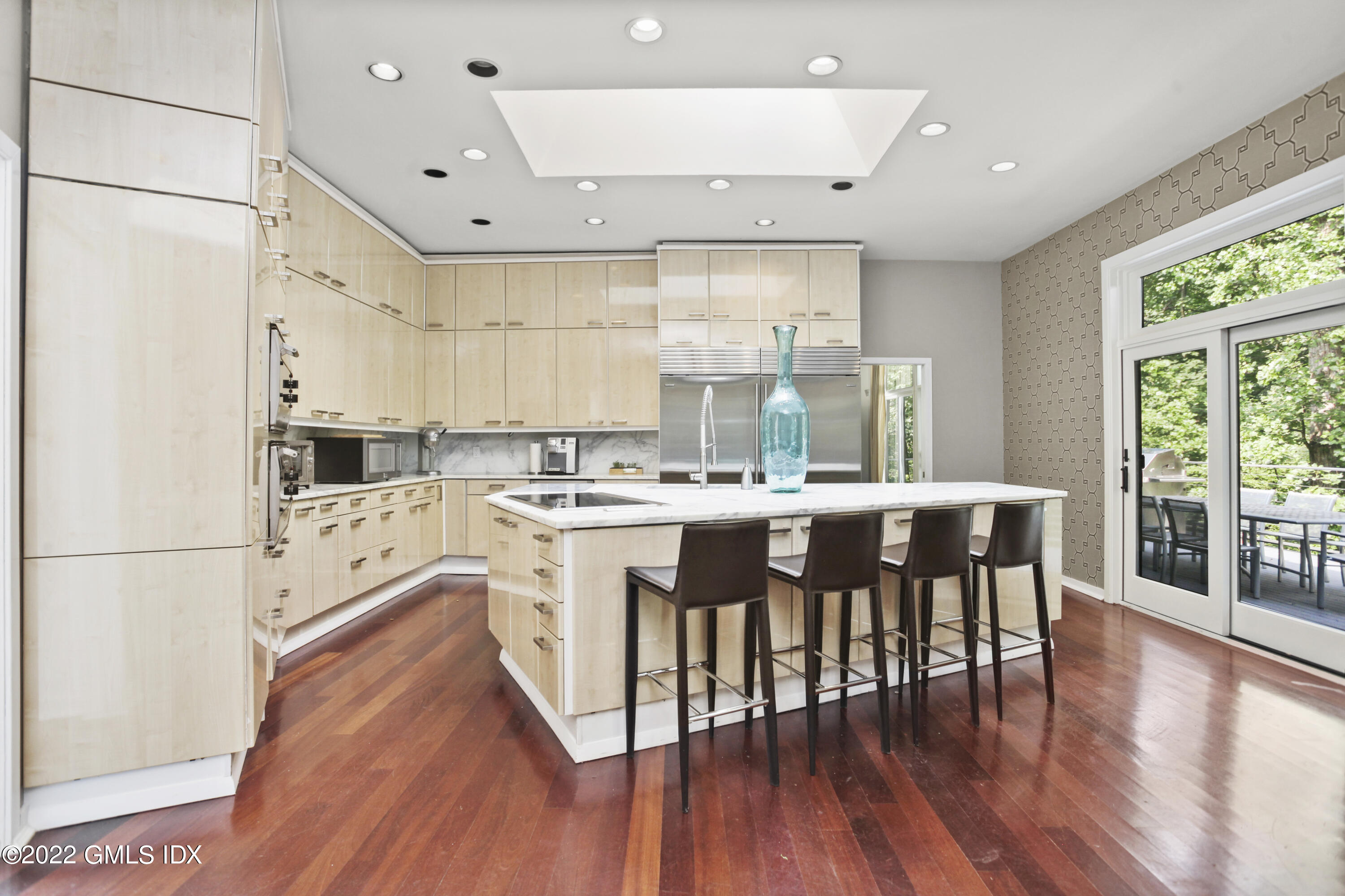 4 Chateau Ridge Road Greenwich, CT 06831 - Photo 16 of 37 a large kitchen with cabinets a sink a center island stainless steel appliances and wooden floor