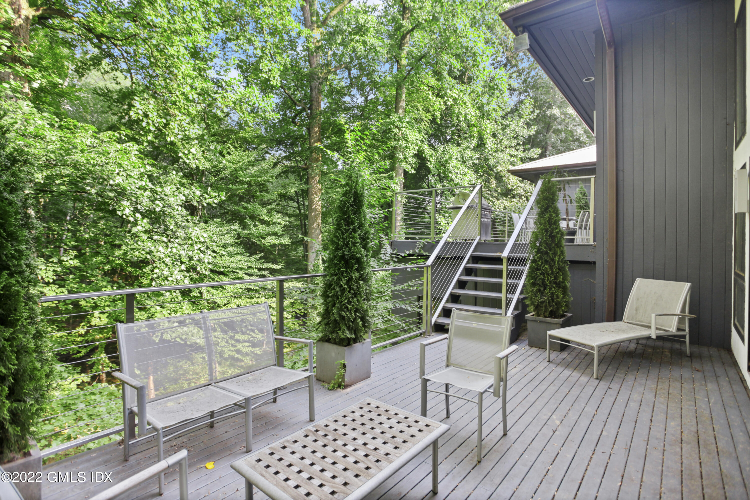 4 Chateau Ridge Road Greenwich, CT 06831 - Photo 21 of 37 a balcony with wooden floor and outdoor seating