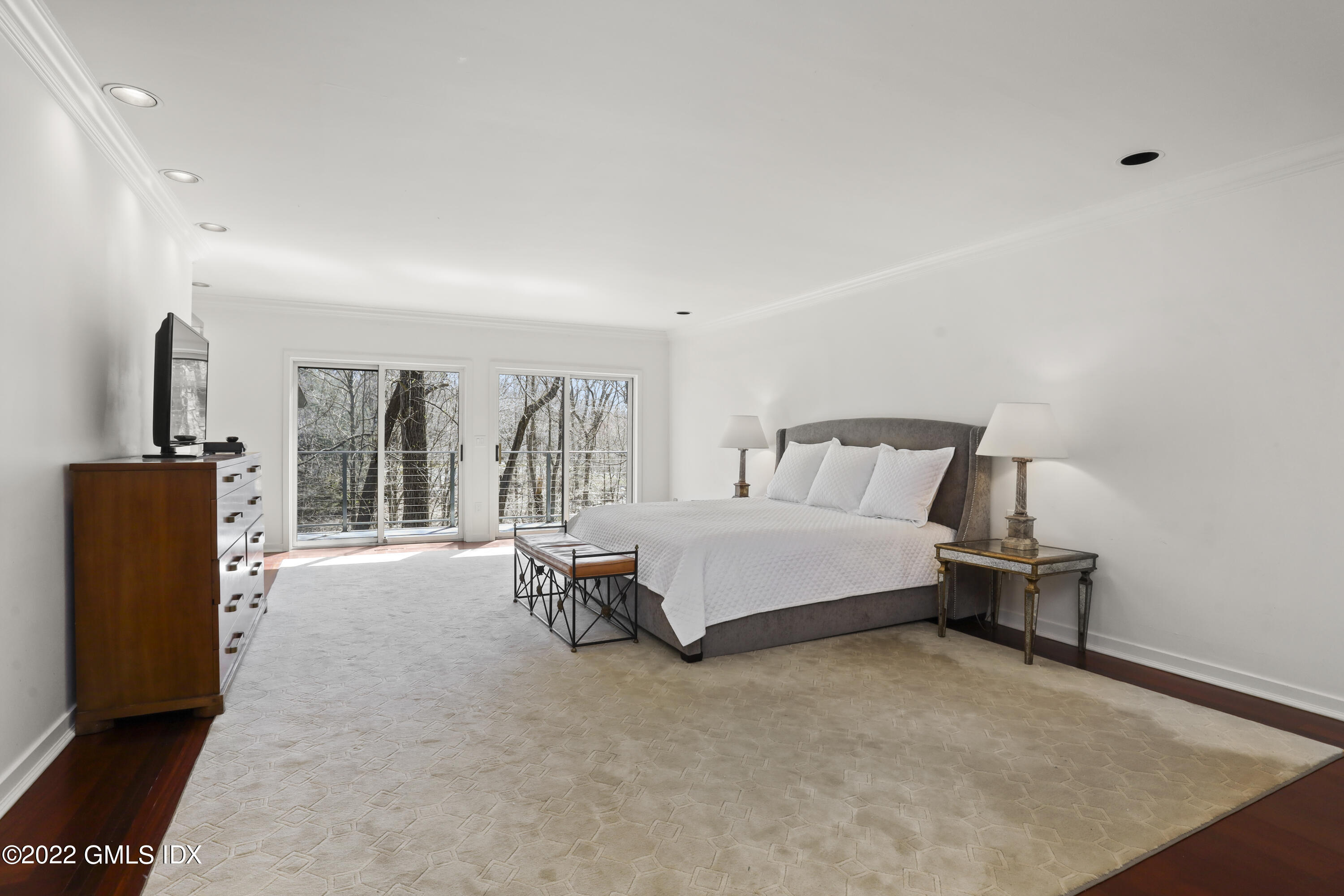 4 Chateau Ridge Road Greenwich, CT 06831 - Photo 23 of 37 a spacious bedroom with a bed and a large window