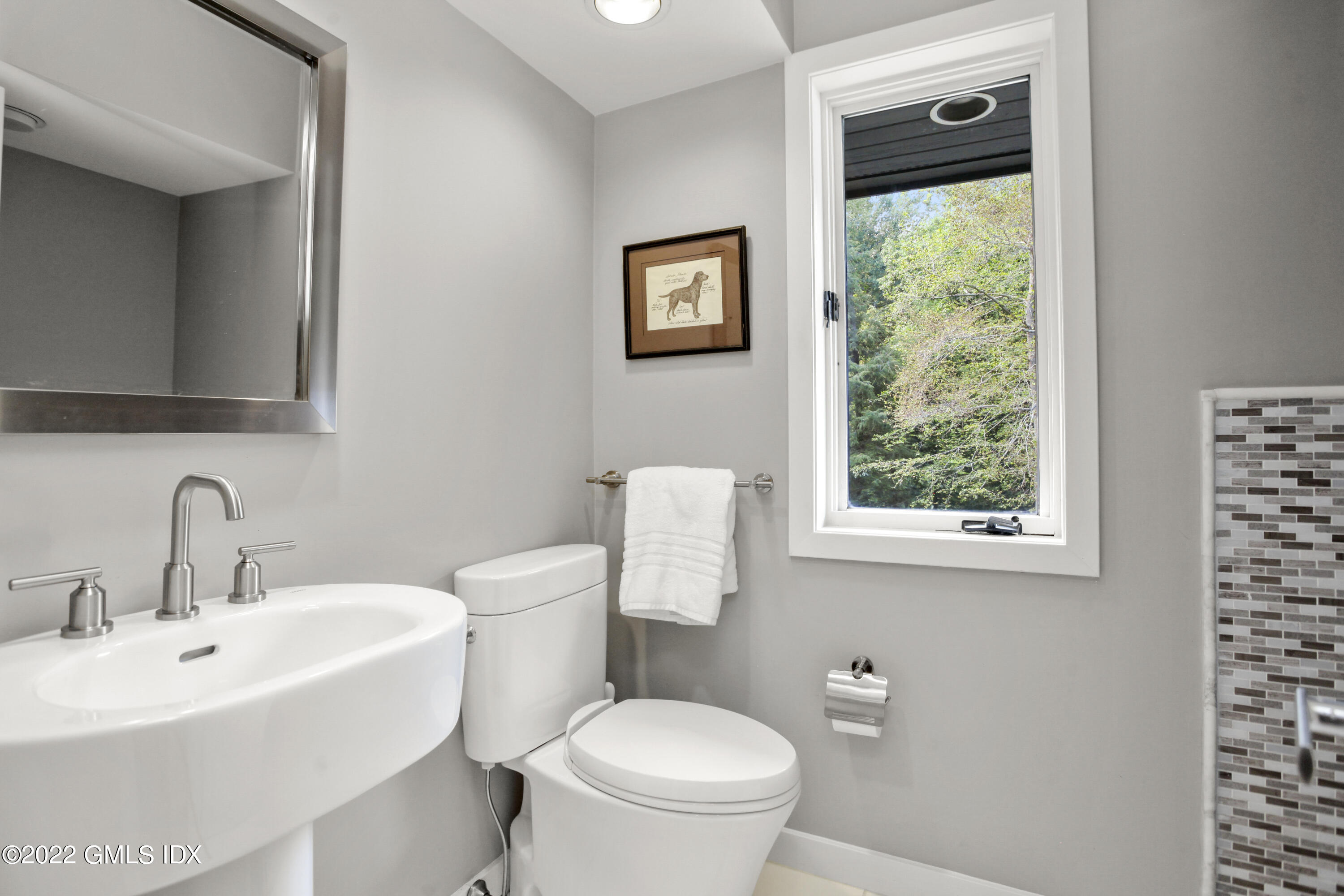 4 Chateau Ridge Road Greenwich, CT 06831 - Photo 28 of 37 a bathroom with a toilet a sink and a window