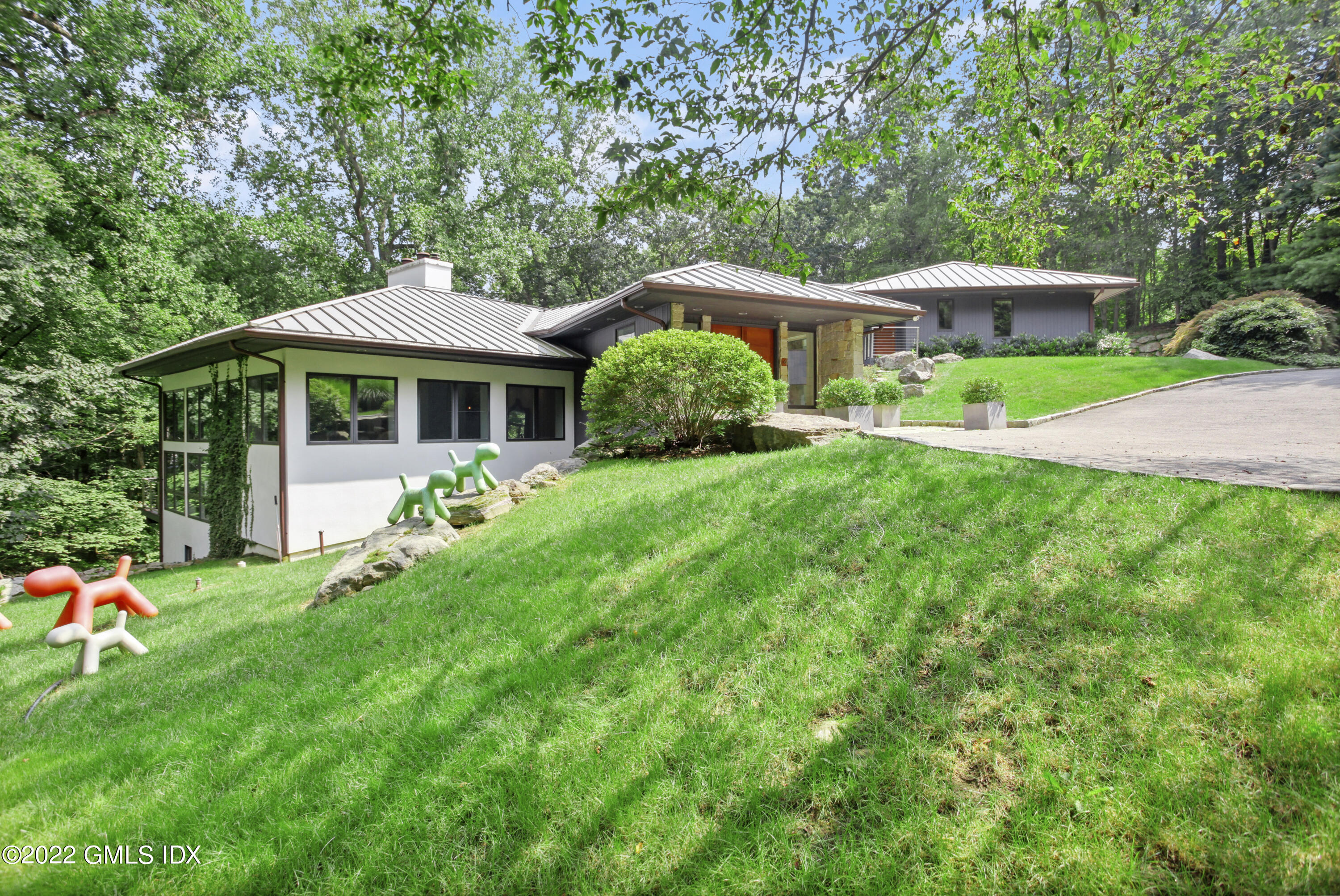 4 Chateau Ridge Road Greenwich, CT 06831 - Photo 4 of 37 a front view of a house with garden