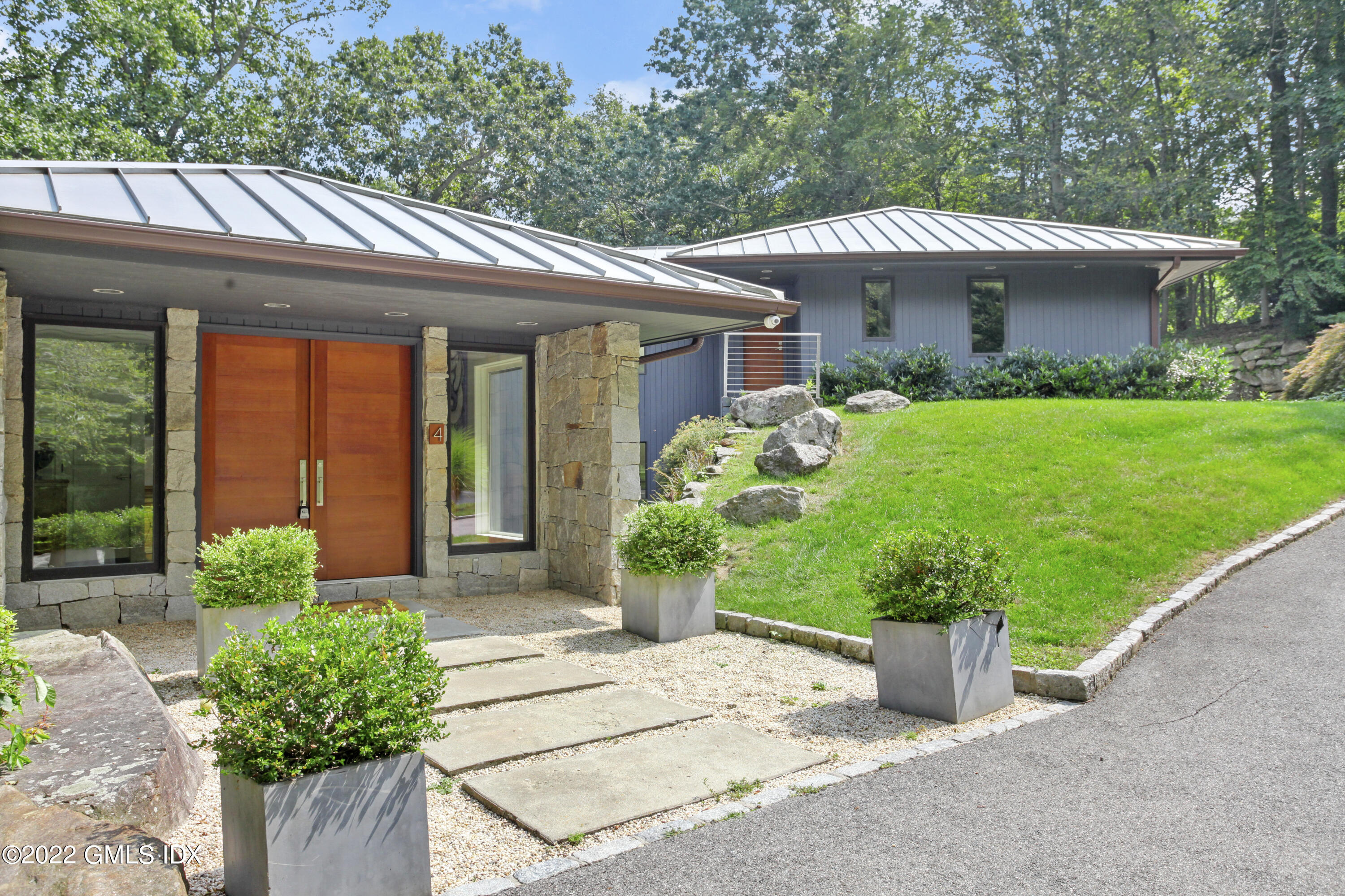 4 Chateau Ridge Road Greenwich, CT 06831 - Photo 5 of 37 a front view of a house with garden