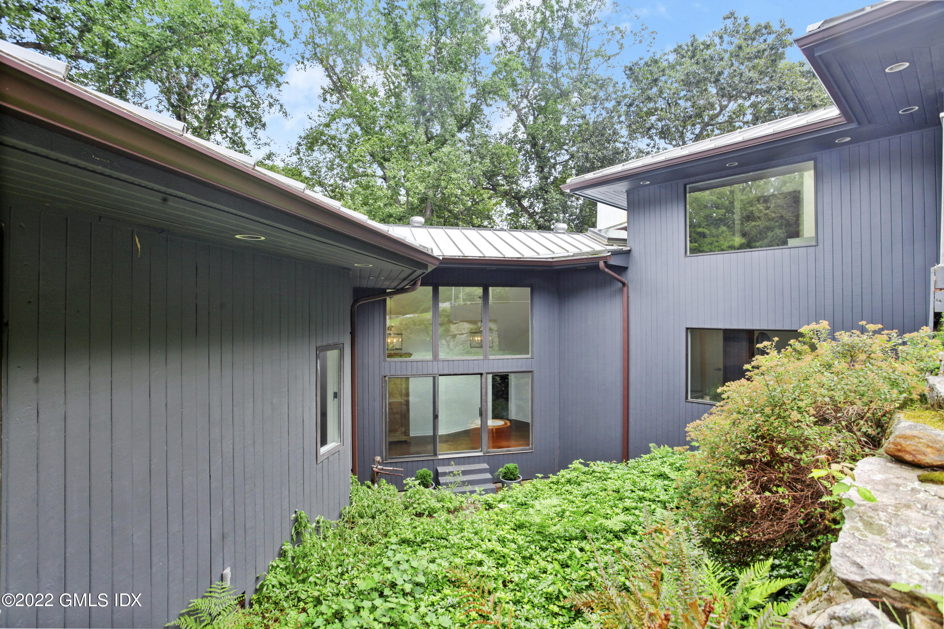 4 Chateau Ridge Road Greenwich, CT 06831 - Photo 6 of 37 a front view of a house with garden