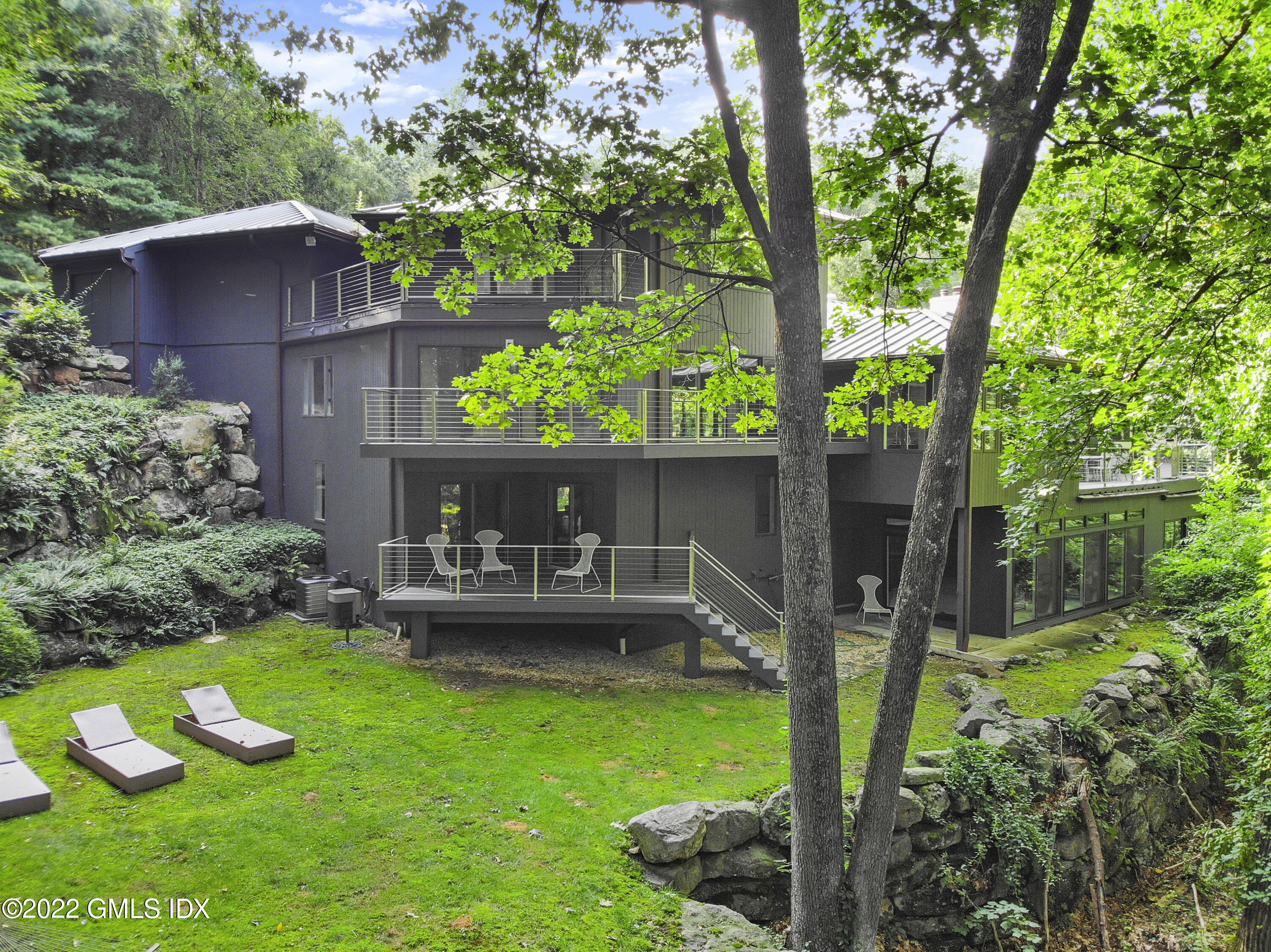 4 Chateau Ridge Road Greenwich, CT 06831 - Photo 7 of 37 a view of a house with backyard sitting area and garden
