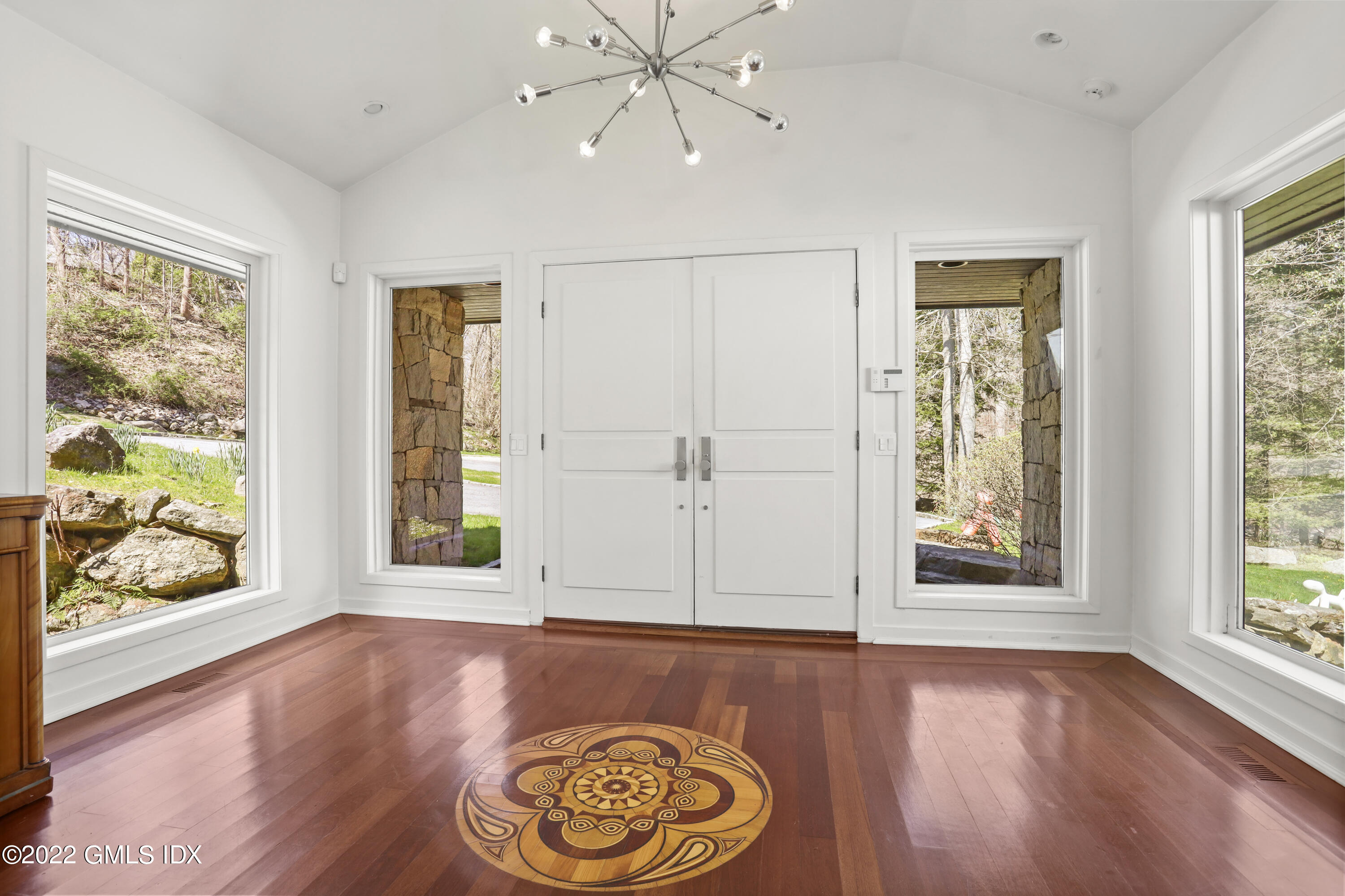 4 Chateau Ridge Road Greenwich, CT 06831 - Photo 9 of 37 a view of an empty room with window and wooden floor