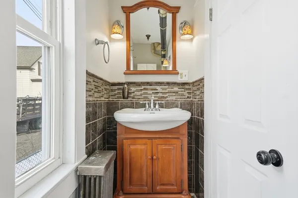 a bathroom with a sink a mirror and a window