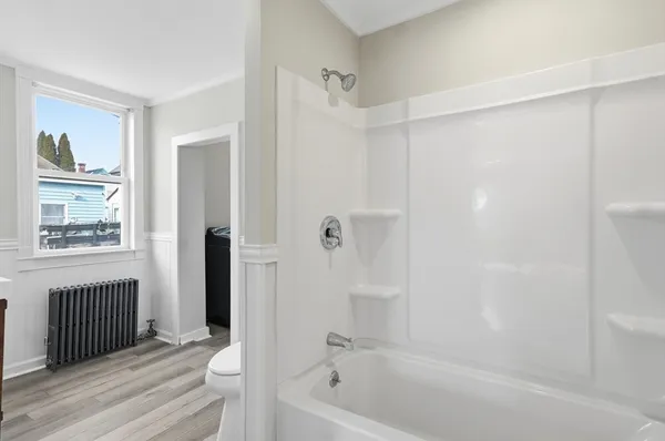 a bathroom with a bathtub and a shower