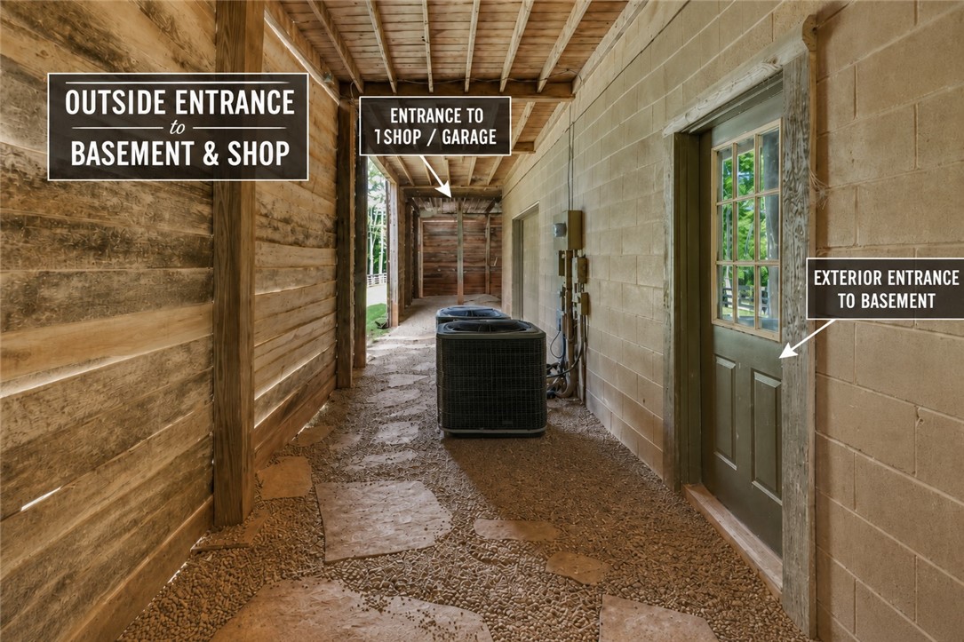 414 Devon Way Anderson, SC 29621 - Photo 33 of 50 A rustic exterior walkway provides distinct access points to the basement and an attached shop/garage.