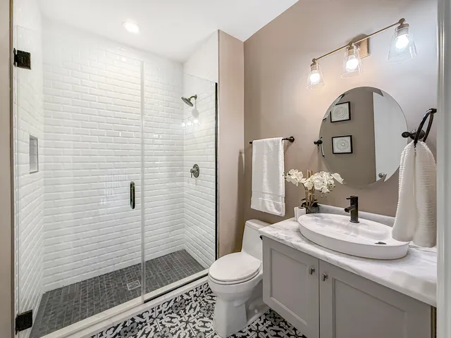 a bathroom with a sink toilet and shower