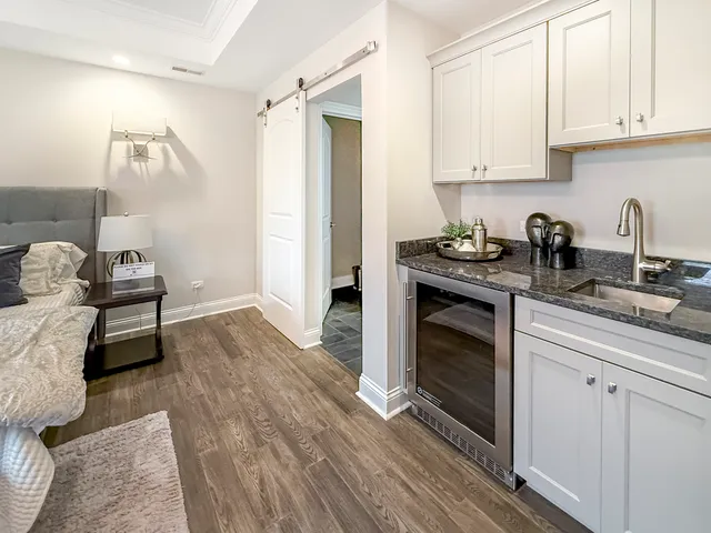 a kitchen with granite countertop a stove a sink and a refrigerator