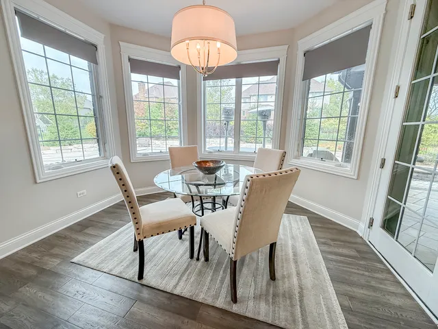 a view of a dining room with furniture a chandelier and wooden floor