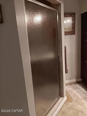 a bathroom with a glass shower door