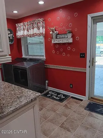 a kitchen with stainless steel appliances granite countertop a refrigerator and a stove