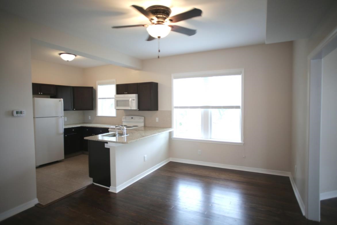 78 Riberia Street St. Augustine, FL 32084 - Photo 12 of 38 a kitchen with stainless steel appliances granite countertop a stove and a refrigerator