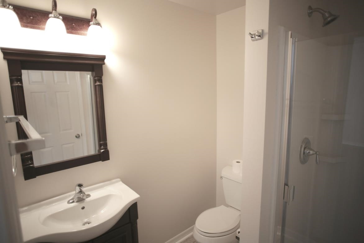 78 Riberia Street St. Augustine, FL 32084 - Photo 17 of 38 a bathroom with a toilet a sink and mirror