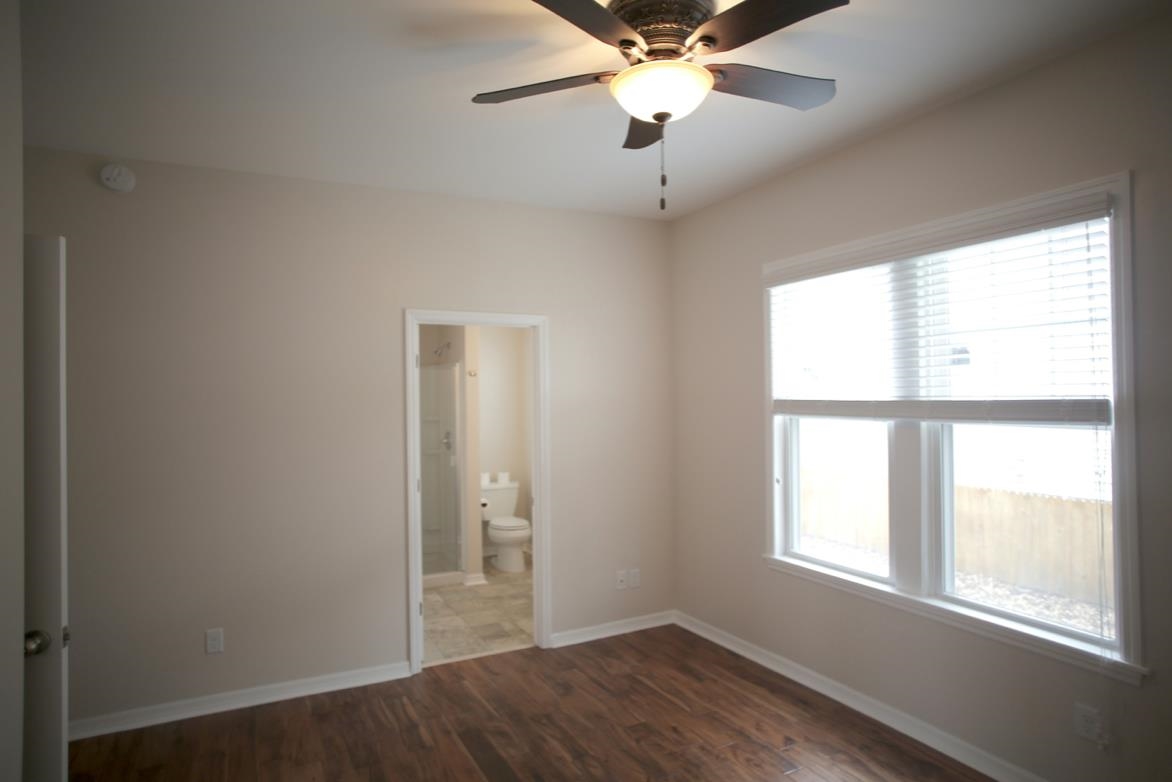 78 Riberia Street St. Augustine, FL 32084 - Photo 19 of 38 an empty room with wooden floor fan and windows