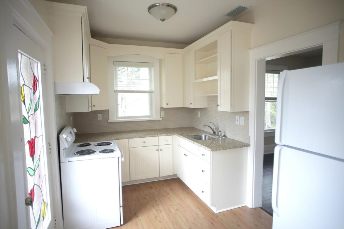 78 Riberia Street St. Augustine, FL 32084 - Photo 26 of 38 a kitchen with a sink a stove a refrigerator and cabinets