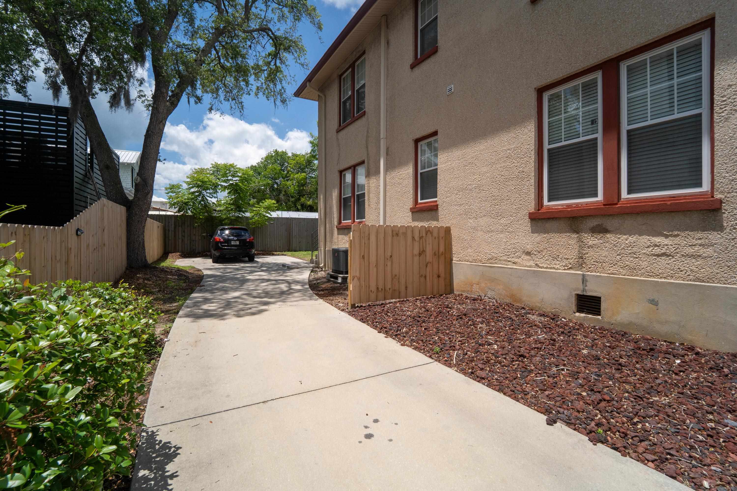 78 Riberia Street St. Augustine, FL 32084 - Photo 7 of 38 a backyard of a house with large trees and plants