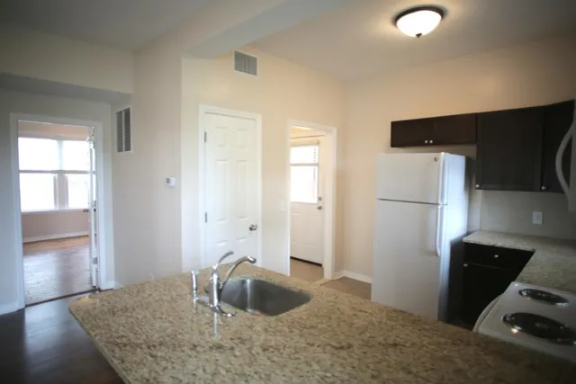 a kitchen with a sink and a refrigerator
