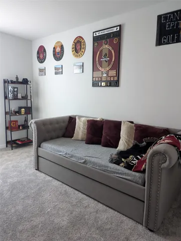 a living room with furniture and wall painting