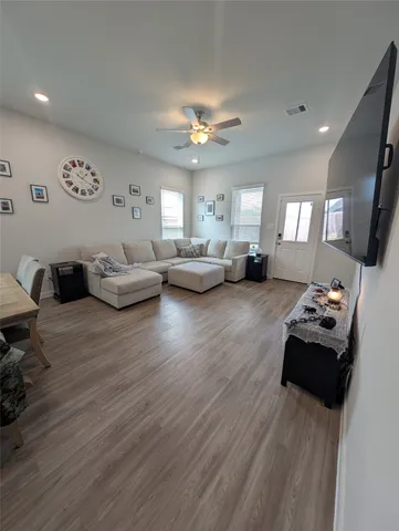 a living room with furniture and a chandelier