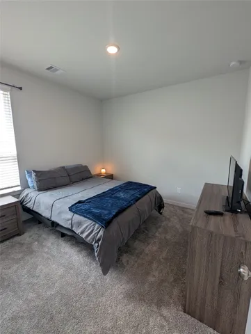 a bedroom with a bed and window