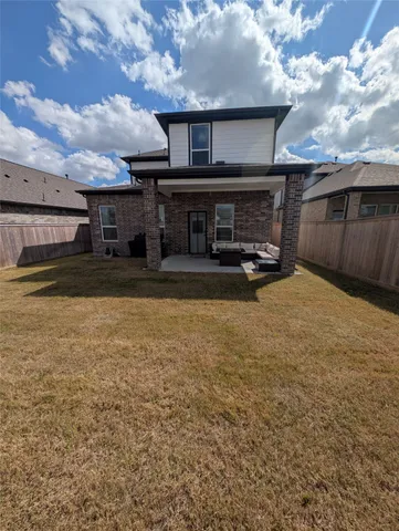 a view of a big house with wooden fence