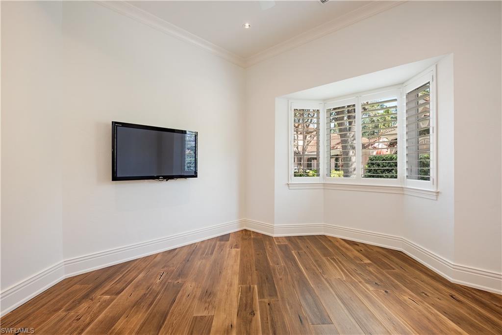 7100 Verde Way Naples, FL 34108 - Photo 12 of 18 a view of an empty room with wooden floor and a window