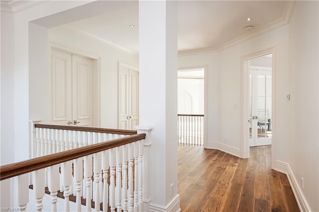 7100 Verde Way Naples, FL 34108 - Photo 14 of 18 a view of a hallway with wooden floor