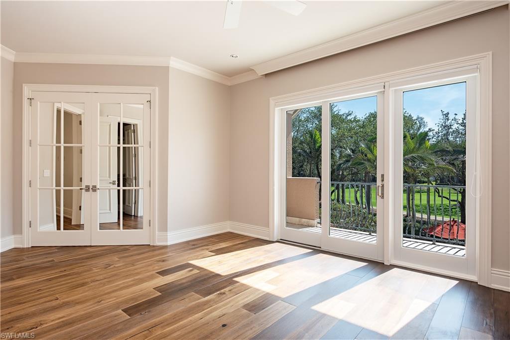 7100 Verde Way Naples, FL 34108 - Photo 15 of 18 a view of an empty room with wooden floor and a window