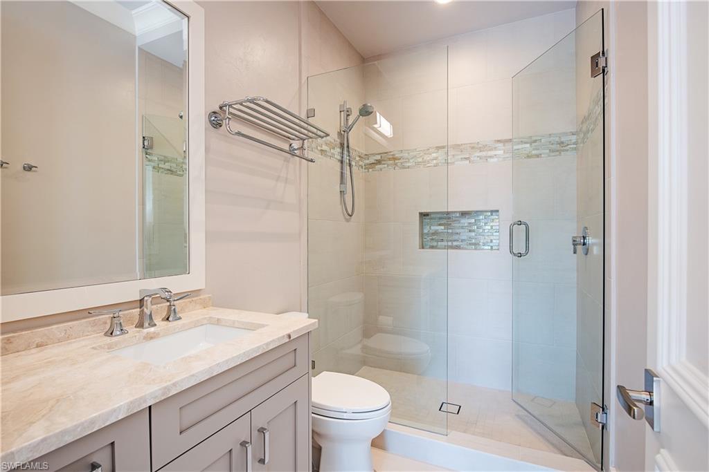 7100 Verde Way Naples, FL 34108 - Photo 18 of 18 a bathroom with a granite countertop sink toilet and shower