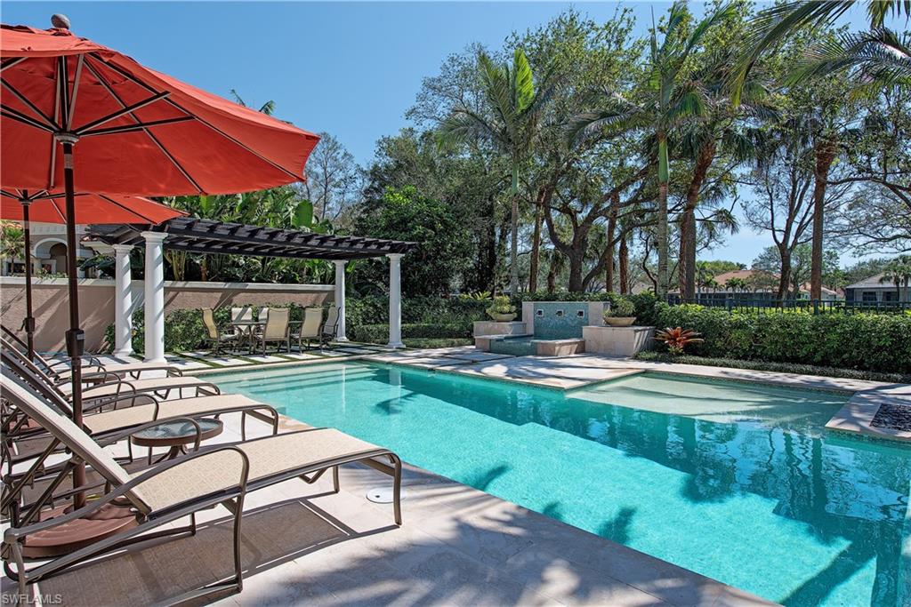 7100 Verde Way Naples, FL 34108 - Photo 2 of 18 a view of a swimming pool with a patio