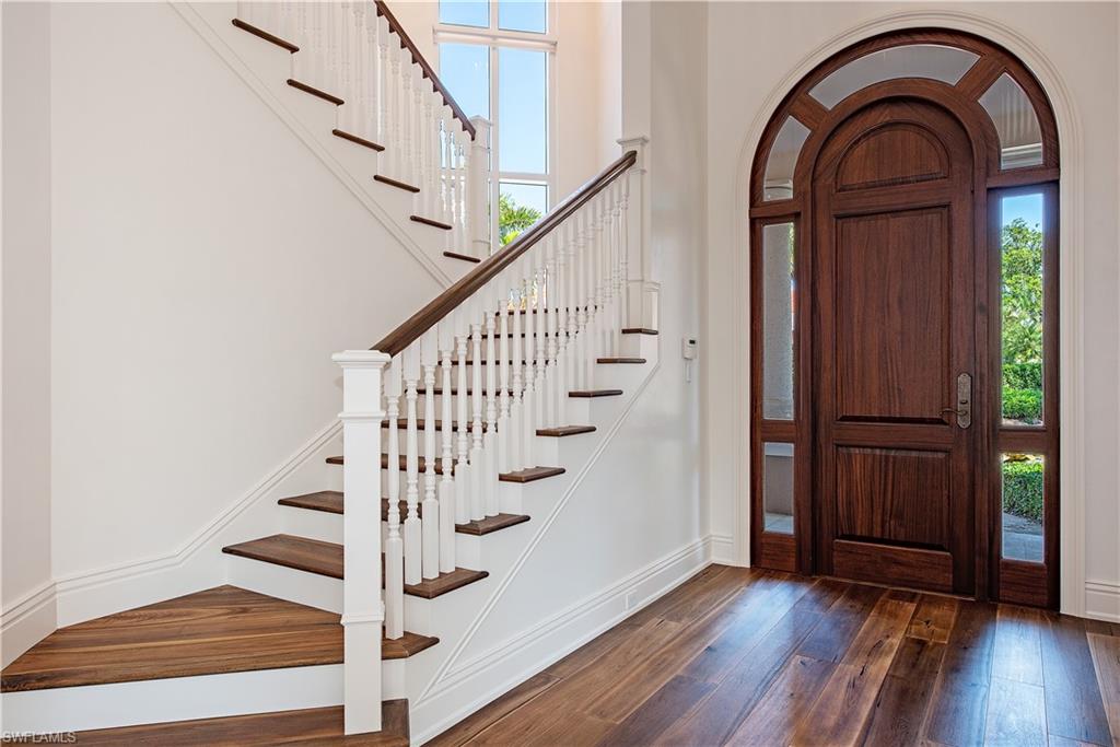 7100 Verde Way Naples, FL 34108 - Photo 5 of 18 a view of entryway with wooden floor and stairs