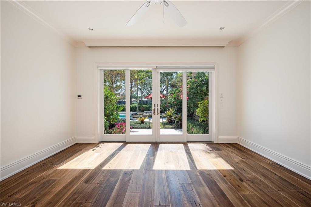 7100 Verde Way Naples, FL 34108 - Photo 10 of 18 a view of empty room with wooden floor and fan