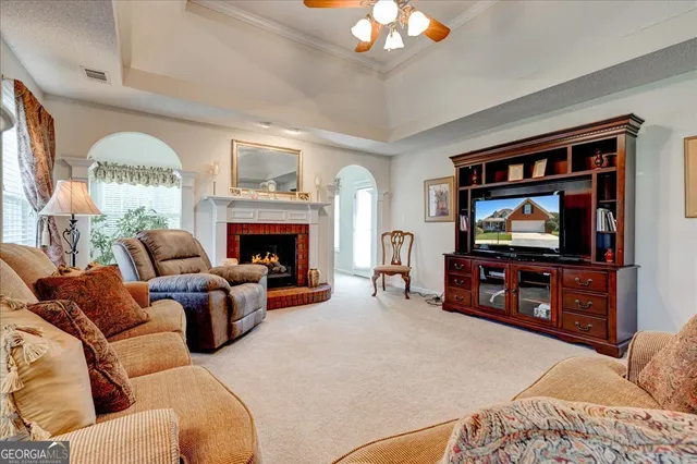a living room with furniture a window and a fireplace