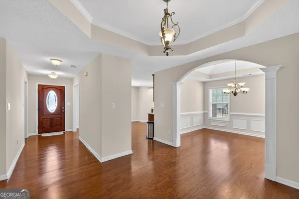 an empty room with windows and cabinet