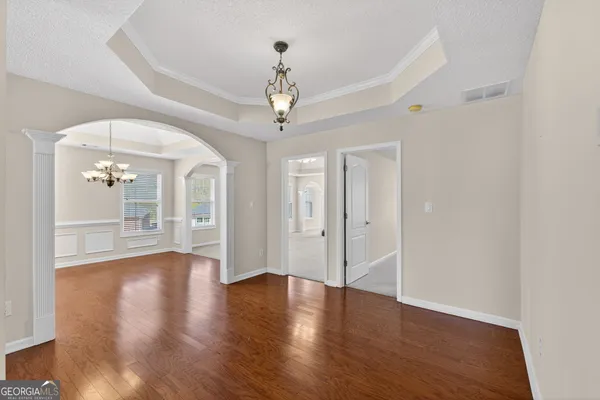 a view of an empty room with a fireplace and a ceiling fan